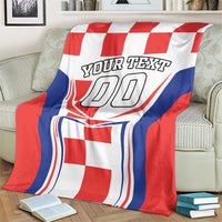 Red, white, and blue checkerboard blanket on chair with 'YOUR TEXT' and '00' artwork