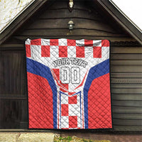 Quilt blanket with red and blue geometric panels and centered “YOUR TEXT 00”