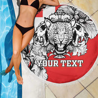 Red round beach blanket with lion leopard head graphic and "YOUR TEXT", fringed edge