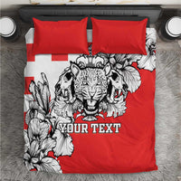 Red bedding set with bold black-and-white leopard heads and floral pattern, plus two red pillowcases