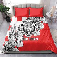 Red bedding set with leopard heads center graphic, black-and-white floral accents, and two red pillows
