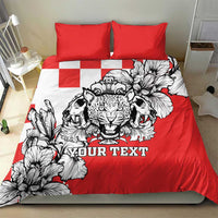 Red and white bedding set with leopard heads artwork, floral details, and two red square pillowcases