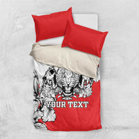 Bedding set top view: red duvet with leopard heads print and black-and-white floral, with two red pillows