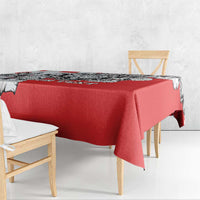 Red tablecloth with black-and-white leopard head print, neatly draped over table