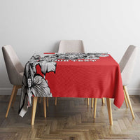 Red tablecloth with black-and-white leopard head print and decorative border
