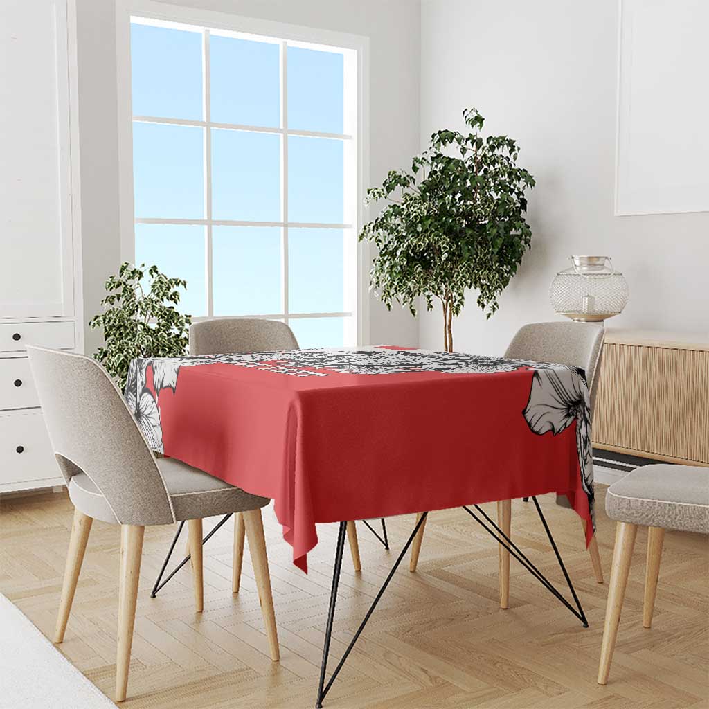 Red tablecloth with black-and-white leopard head design shown on a dining table