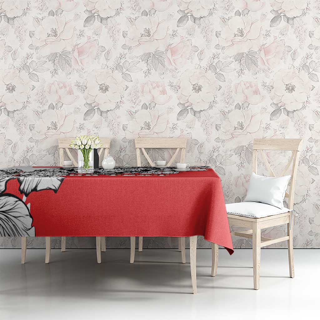 Red tablecloth featuring black-and-white leopard heads across the table surface