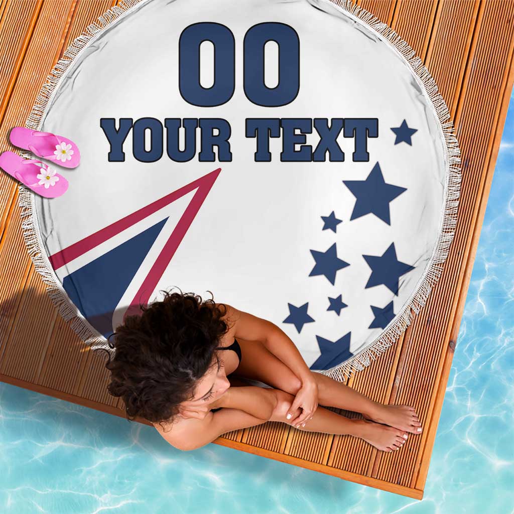 Round white beach blanket with blue stars, red-and-blue USA emblem, and “YOUR TEXT”; fringed edge.