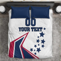 White comforter with two navy pillows; large '00' and 'YOUR TEXT' over stars and flag graphic