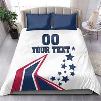 White bedding set with two navy pillowcases; comforter with '00', 'YOUR TEXT', stars, flag graphic