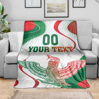 White throw blanket with eagle emblem, green/red waves, and 'YOUR TEXT' text