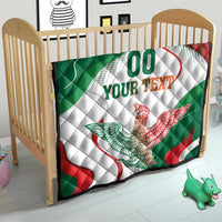 Baby quilt with Mexican flag colors, “00 YOUR TEXT” and eagle graphic, in crib