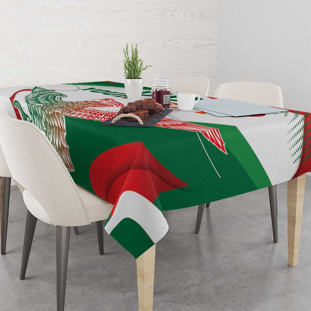 White tablecloth with green and red eagle monument design, draped over dining table