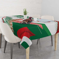 White tablecloth with green and red eagle monument design, draped over dining table