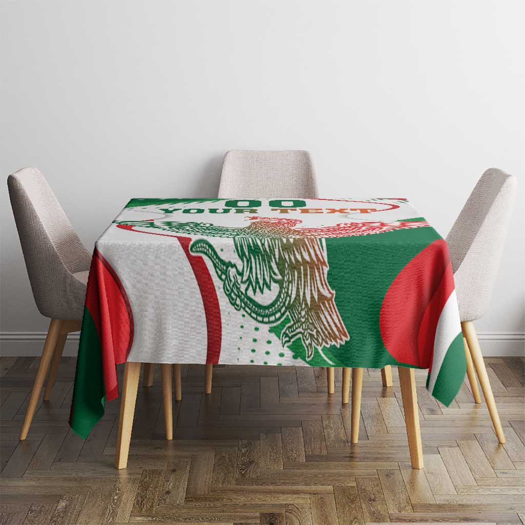 White rectangular tablecloth with green and red eagle monument artwork on tabletop