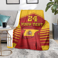 Spain-themed sports blanket over a sofa arm, red/yellow design with 24 and Your Text