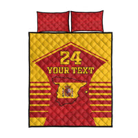 Red and yellow quilt with custom text and crest emblem, with two red pillow covers.