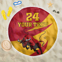 Red and yellow round beach blanket with fringe edge, bull graphic, and “YOUR TEXT”.