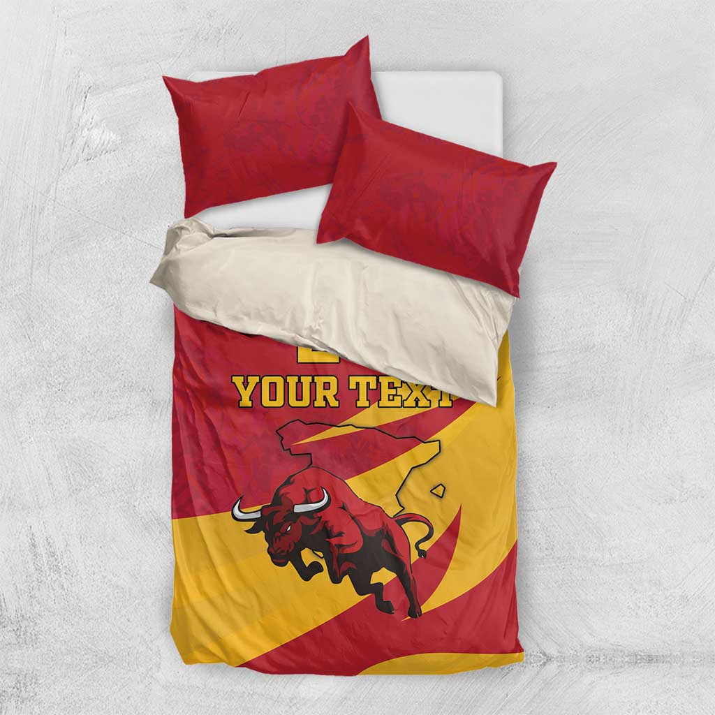 Red and yellow bedding set with bull graphic and “Your Text” on duvet, two red pillows