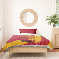 Red and yellow duvet cover with bull graphic, “24” and “Your Text,” on a bed frame
