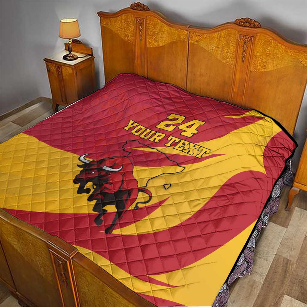 Red and yellow quilt blanket on bed with bull graphic and '24 YOUR TEXT' design