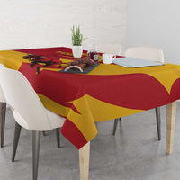 Bull-themed tablecloth in red and yellow over dining table with place settings