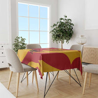 Red and yellow bull-themed tablecloth on dining table with neatly draped hem