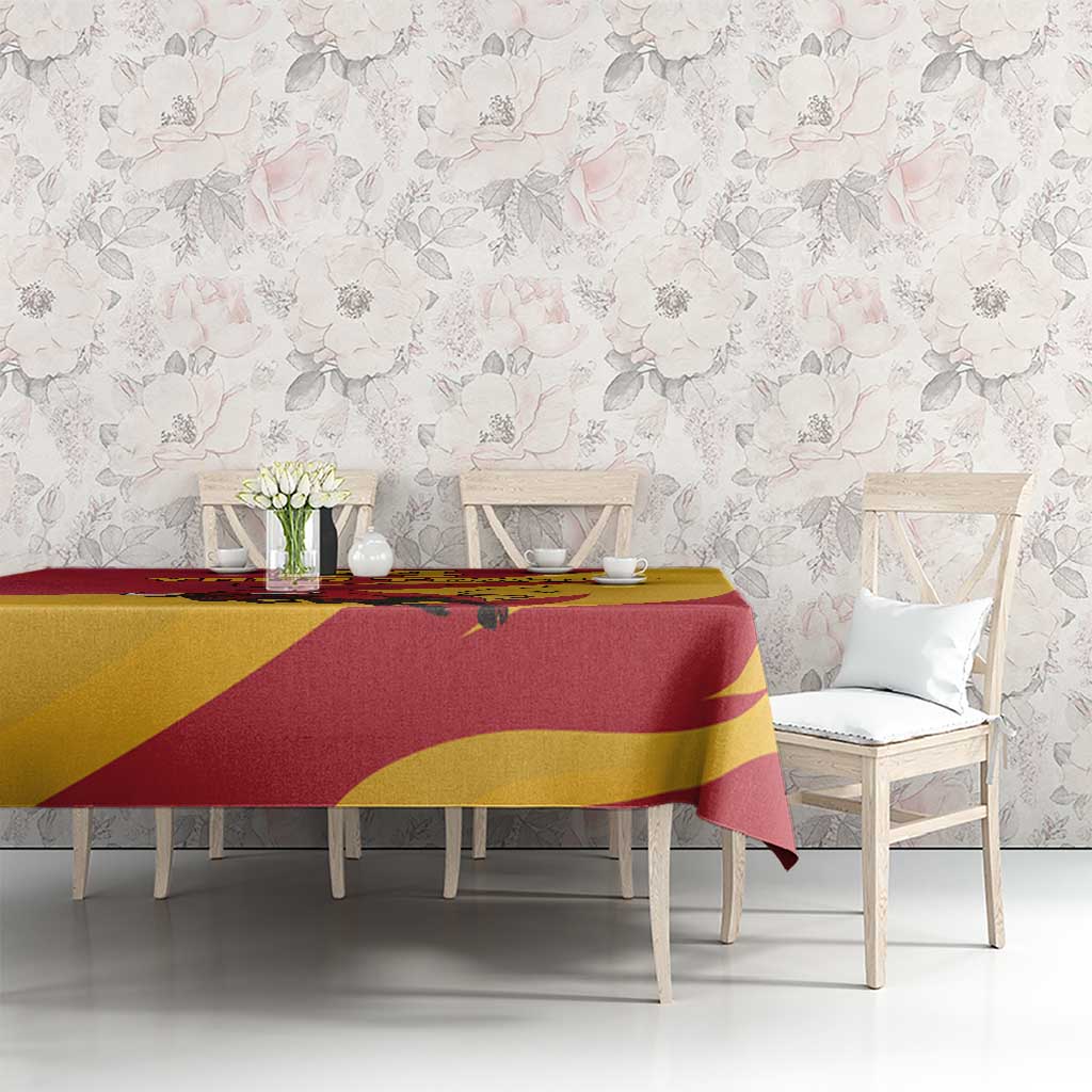 Red and yellow bull tablecloth with flower motifs, draped over dining table
