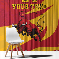Close-up view of red and gold curtain fabric with bull graphic and large custom text.