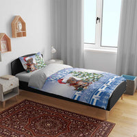 Blue Christmas bedding set on bed with Santa-hat kitten, Christmas tree, lights, and patterned trim