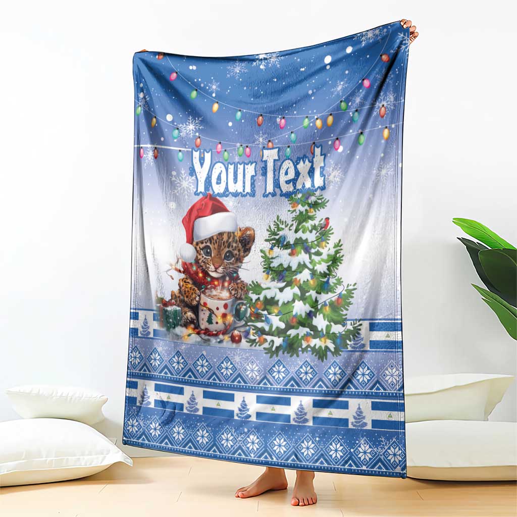 Blue Christmas throw blanket draped with “Your Text”, jaguar in Santa hat and tree