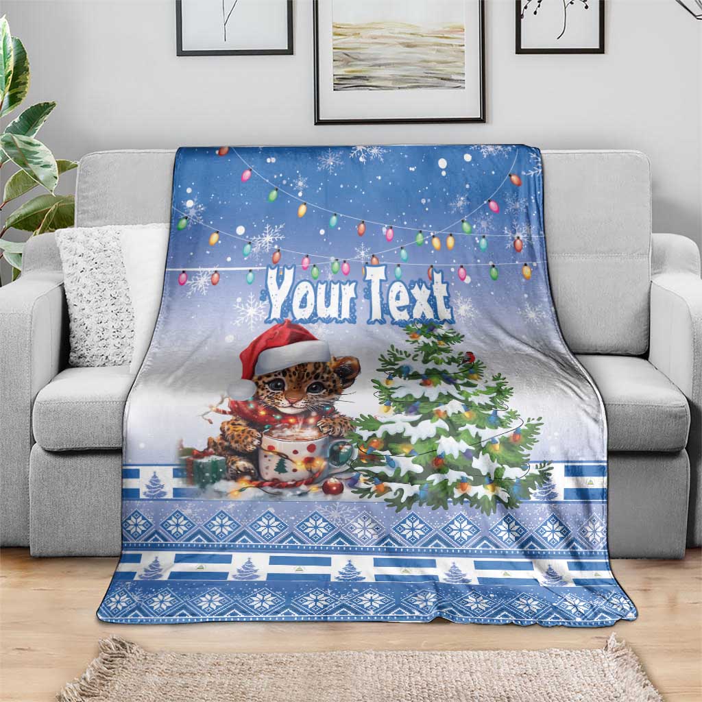 Blue Christmas blanket spread out, “Your Text” over jaguar in Santa hat beside tree