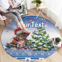 Blue round Christmas carpet with leopard cat wearing Santa hat, presents, and Christmas tree