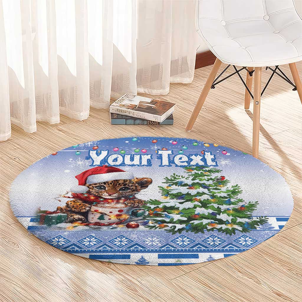 Blue round Christmas carpet with 'Your Text', leopard cat in Santa hat next to Christmas tree