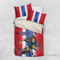 Red football bedding set with lion soccer design, 'YOUR TEXT' and striped pillowcases.