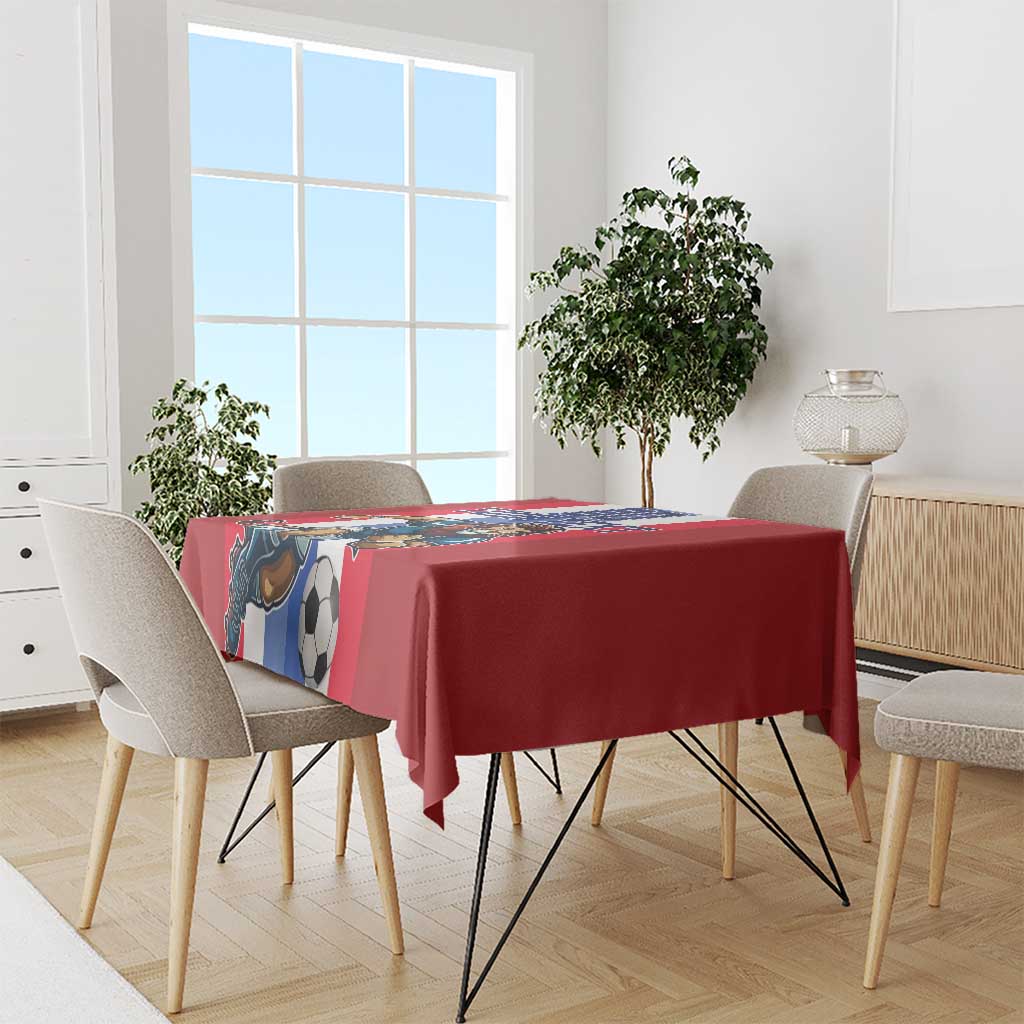 Red football tablecloth draped on dining table with lion and soccer ball graphic