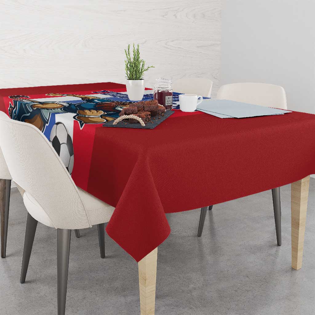 Red football tablecloth with lion and soccer ball graphic on dining table corner