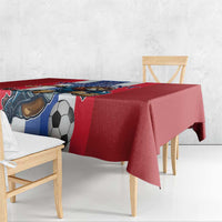 Red football tablecloth with soccer ball and lion mascot print along table edge