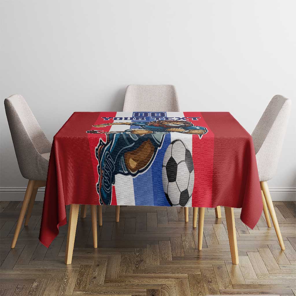 Red football tablecloth with lion mascot and soccer ball graphic on dining table center