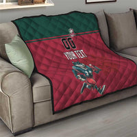 Rugby quilt draped over sofa arm: dark green panel, red quilted design, wolf mascot, "YOUR TEXT"