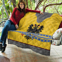 Yellow quilt blanket with gray panel, blue band, and black double-headed eagle emblem