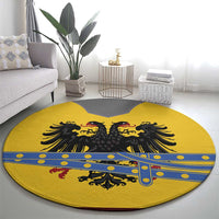 Round yellow rug with black double-headed eagle crest and blue border pattern