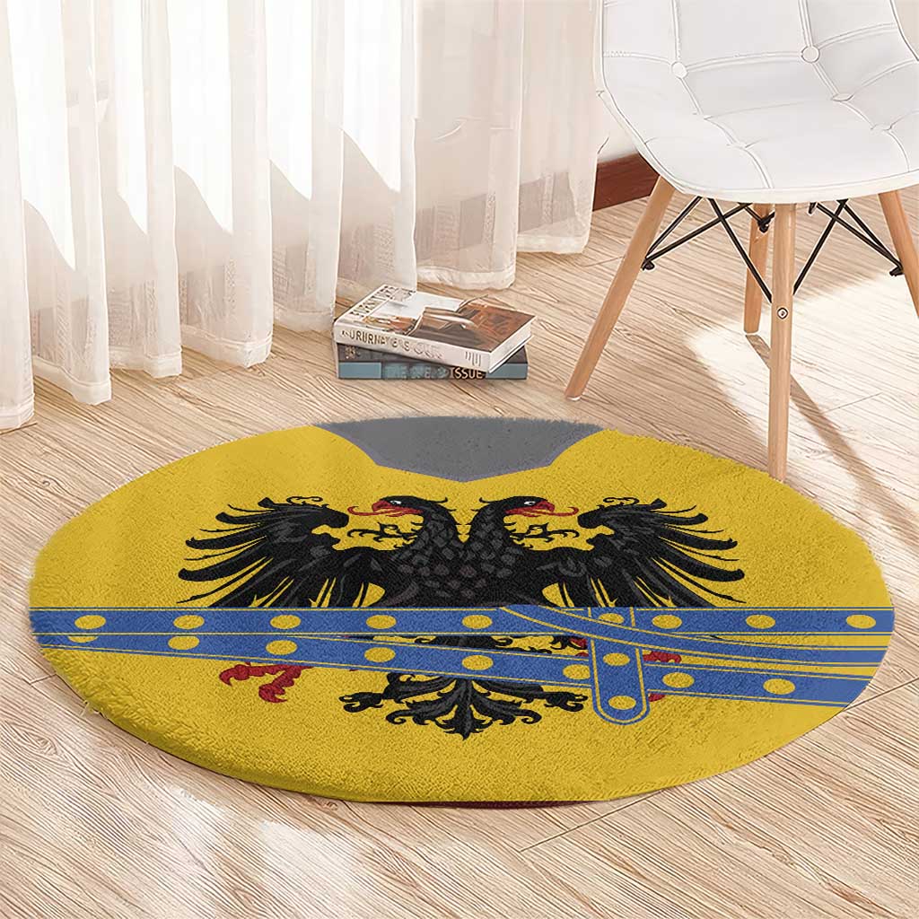 Round yellow rug with black eagle crest, blue bar-and-dot trim