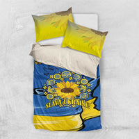 Blue and yellow bedding set with yellow pillowcases and sunflower emblem, flat-lay view