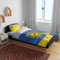 Blue duvet cover on a bed with yellow pillowcases, sunflower peace sign and folk design