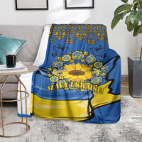 Blue and yellow folk sunflower blanket on floor beside chair, “SLAVA UKRAINE!”
