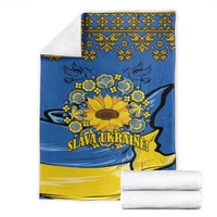Folded blue and yellow folk sunflower blanket with “SLAVA UKRAINE!”