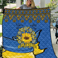 Blue and yellow quilt with folk border, sunflower peace sign, and dove silhouette