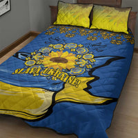 Blue quilt with large yellow sunflower peace sign and folk patterns, with two pillows
