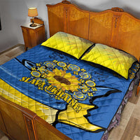 Blue quilt bed set with yellow pillowcases and sunflower peace sign folk design
